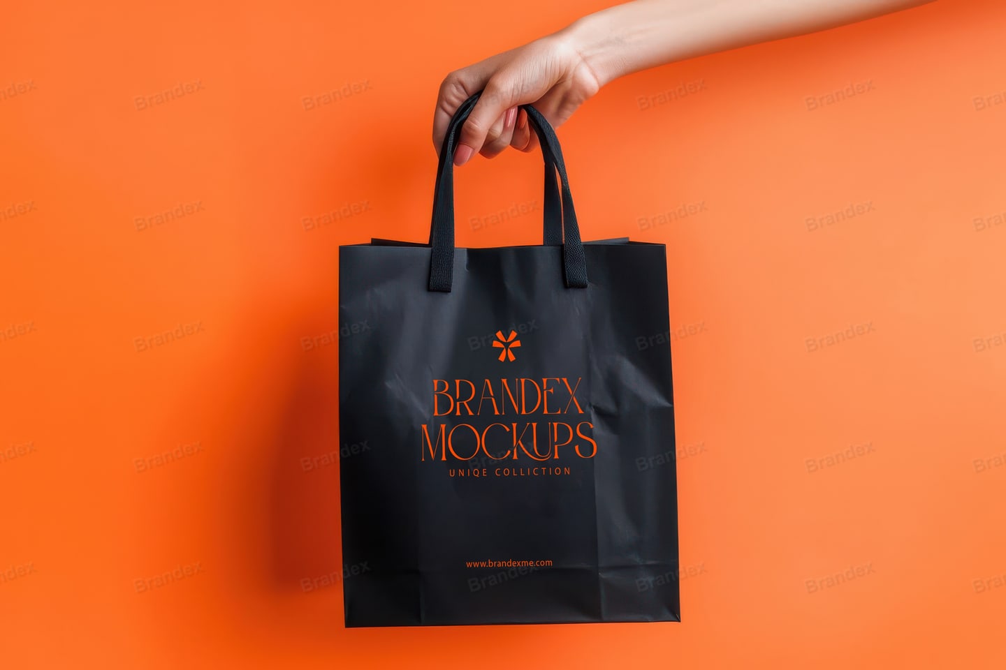 Black Paper Shopping Bag Mockup Held in Hand – Orange Studio Background