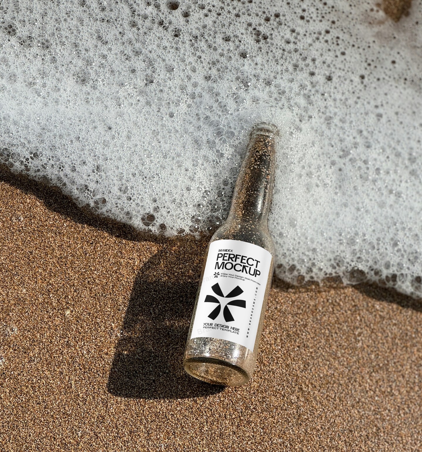Clear Glass Bottle Mockup on Sandy Beach with Sea Foam